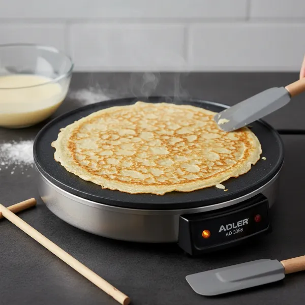 Golden-brown crepe being cooked on the non-stick surface of the Adler AD 3058 crepe maker.
