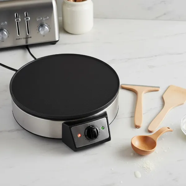 Euro Cuisine CM20 electric crepe maker with wooden batter spreader, crepe turner, and ladle.
